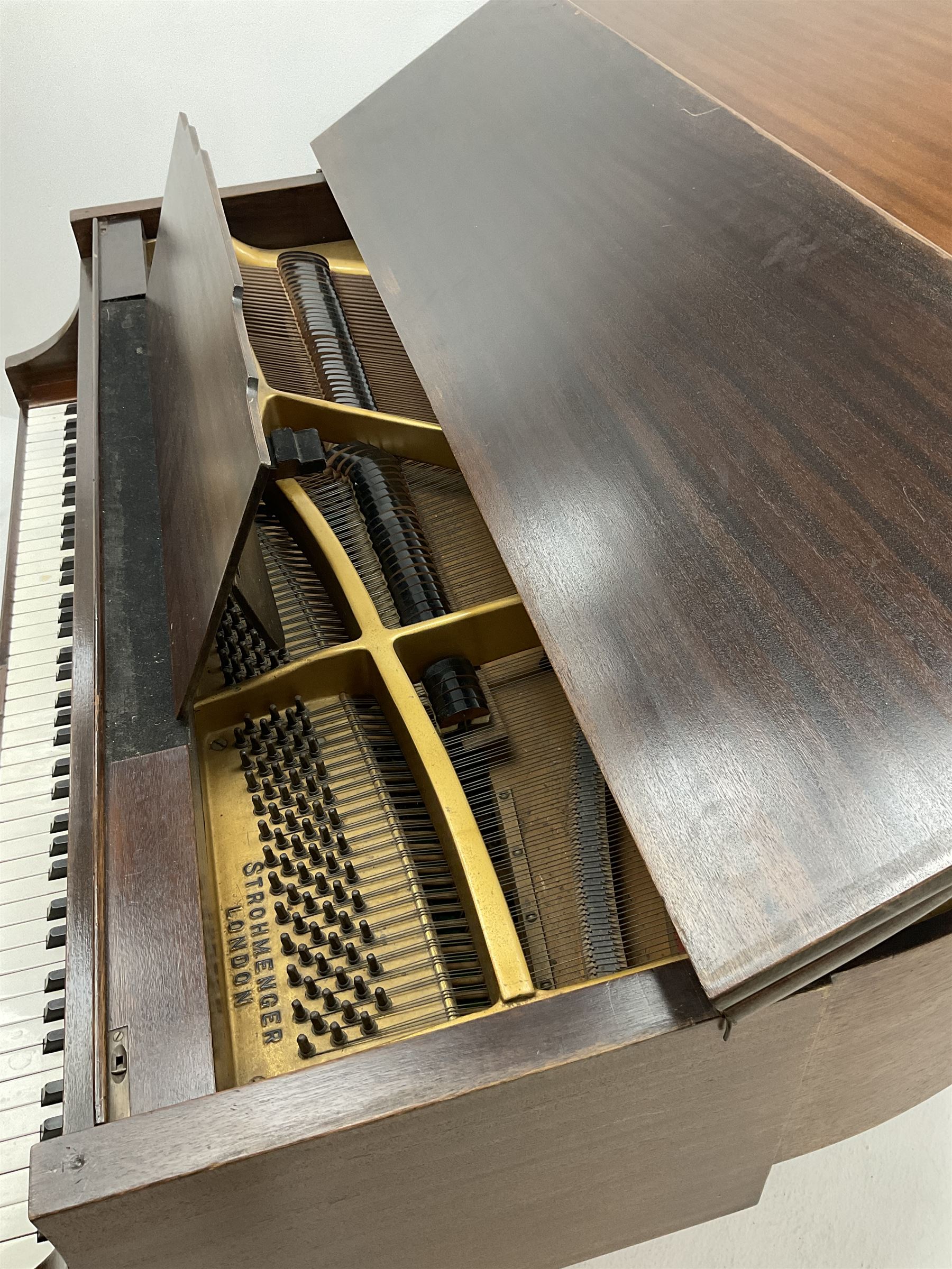 Early 20th century mahogany cased Strohmenger London baby grand piano, demi lune shape, over strung cast iron framed, raised on square tapered supports and castors 