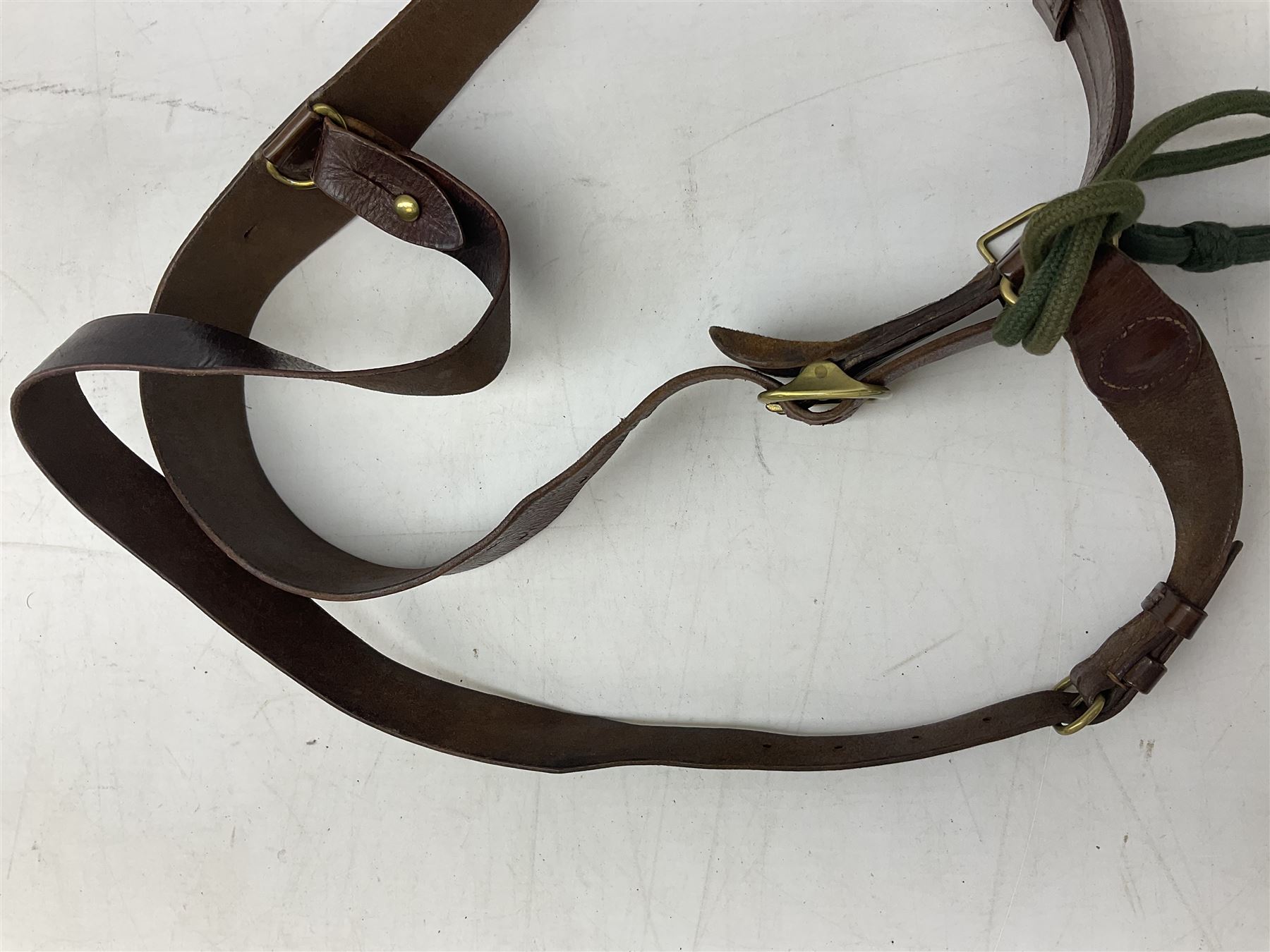 British Army Officers Sam Browne leather belt with shoulder strap; and webbing belt with Potter London Staybrite buckle for 19th Regiment of Foot (Green Howards) with various markings (2)