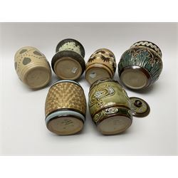 A group of Doulton Lambeth and Royal Doulton tobacco jars, to include examples with relief moulded foliate decoration, each with impressed marks and markers monograms beneath. 