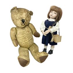 Mid-20th century woodwool filled teddy bear; and porcelain doll dressed as a WW2 evacuee