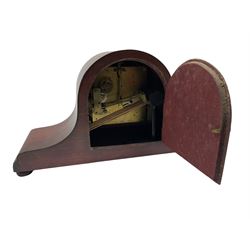 A mahogany cased Tambour clock with a German eight-day movement sounding the quarters and hours on gong rods, with a 6” silvered dial , Arabic numerals and minute track, steel spade hands within a spun brass bezel and convex glass.
With pendulum. 




