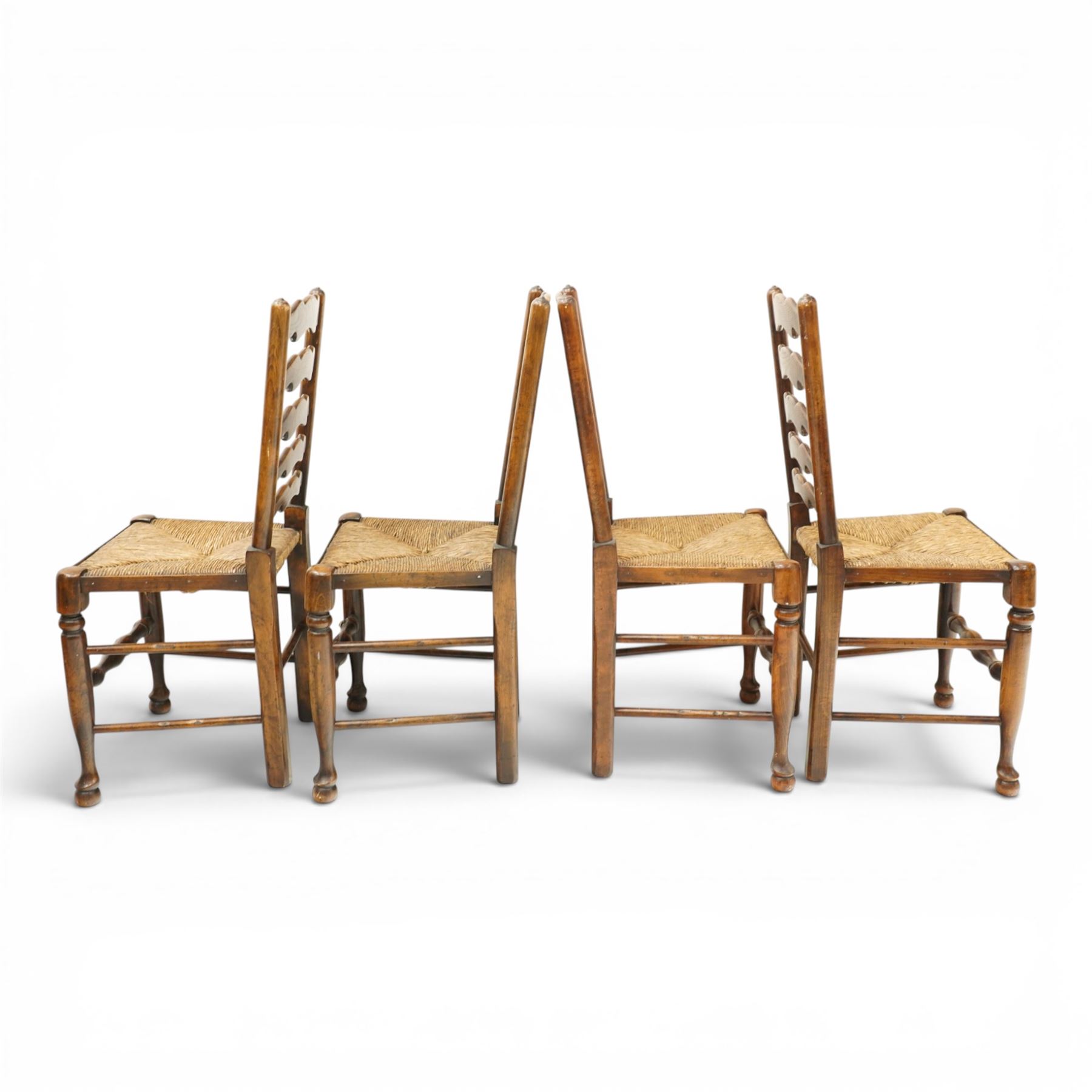 Set of eight country ladderback chairs (6+2), shaped ladderback over a rush seat, raised on turned supports, united by stretchers