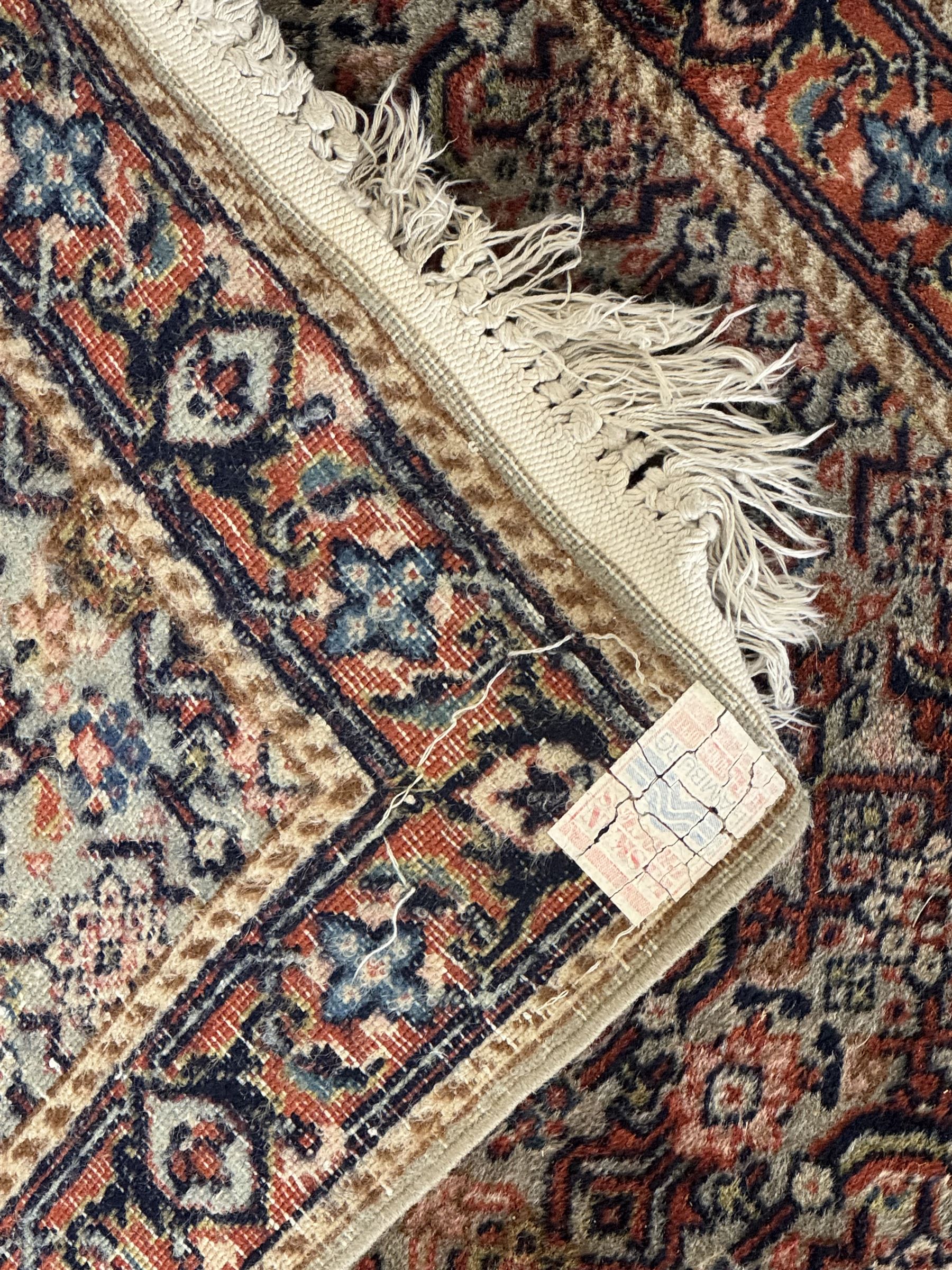 Persian-style wool rug, cream field with floral and geometric motifs, wide floral border (74cm x 142cm); Persian wool rug, beige field with dense floral patterns, narrow floral border (70cm x 144cm); Tribal wool rug, red and navy with diamond motifs (96cm x 60cm); Persian pictorial wool rug, black field with vase, birds, and floral border (70cm x 73cm)
