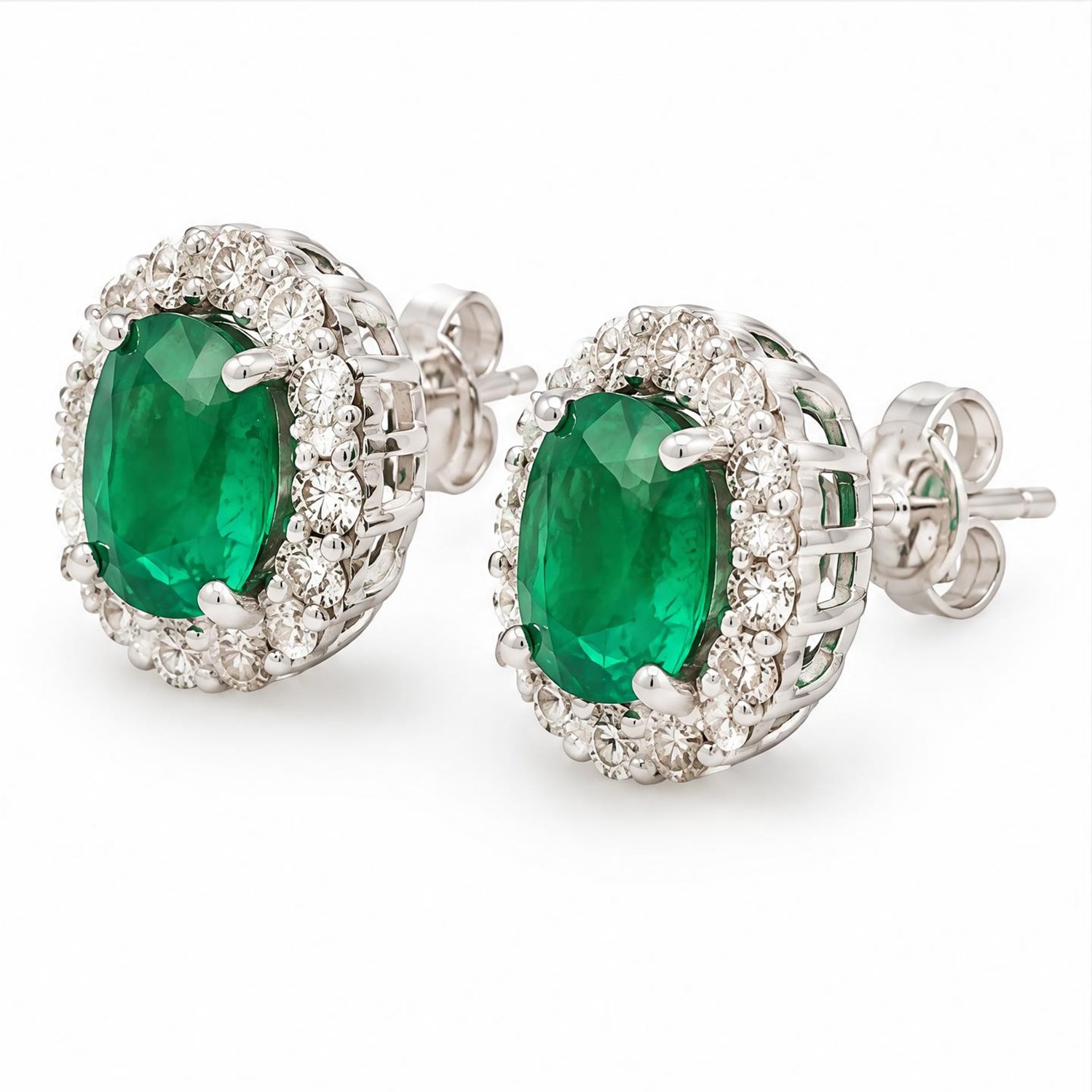 Pair of 18ct white gold emerald and diamond cluster earrings, each stud set with a cushion cut emerald surrounded by fourteen round brilliant cut diamonds, stamped, total emerald weight approx 2.50 carat, total diamond weight approx 0.65 carat