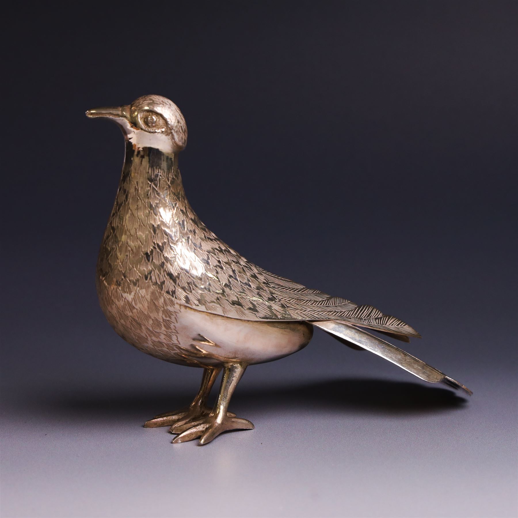 Mid 20th century Iranian silver model of bird, with engraved feathers, stamped with lion with scimitar to underside of tail, H11cm
