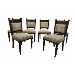 Set of six Edwardian carved oak salon chairs, the cresting rail carved with foliate and flower heads