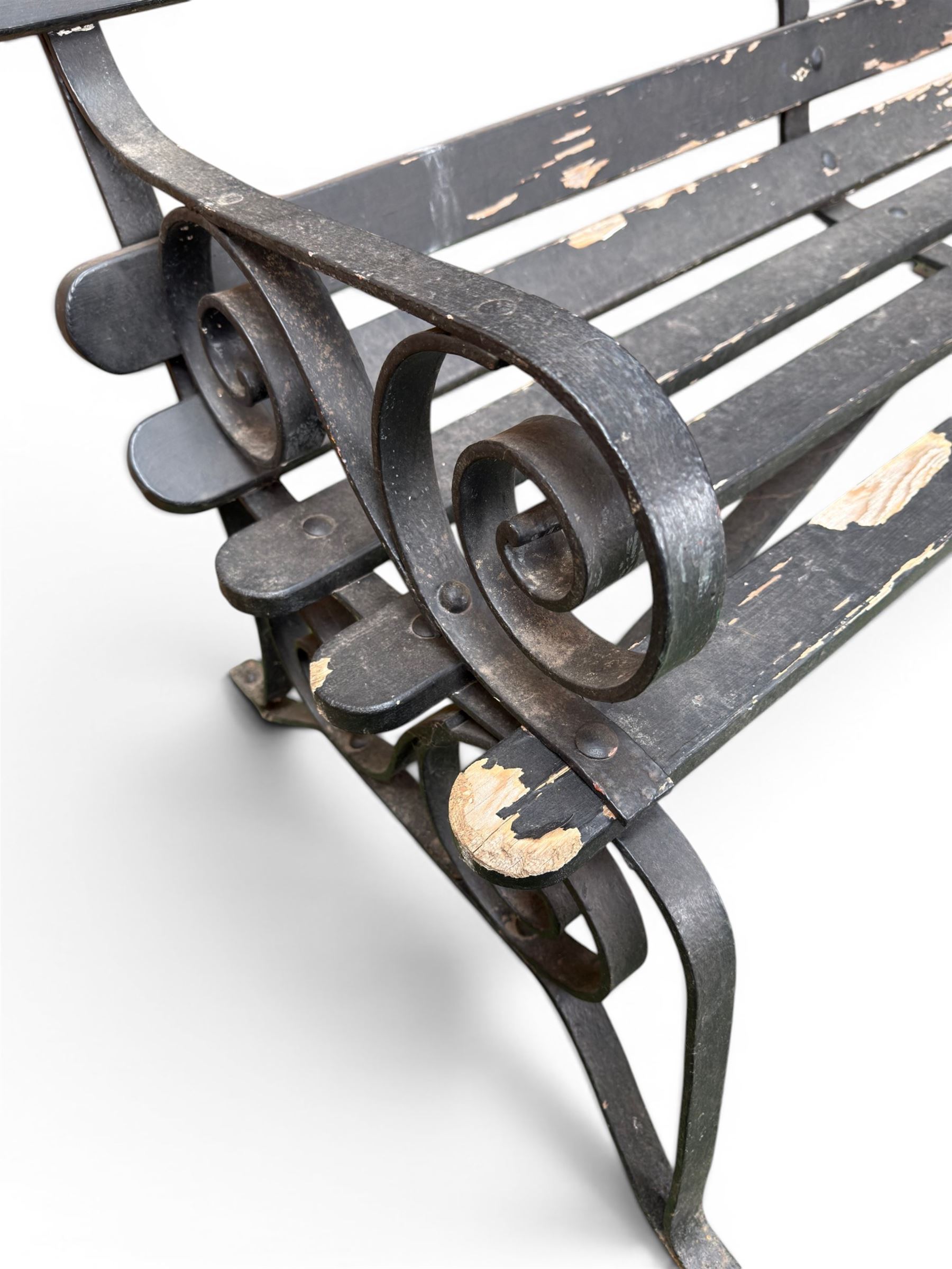 Coalbrookdale - rare pair of wrought iron and slatted wood garden benches, the twin wrought iron strapwork bench-ends formed of four scrolls over splayed feet, number 77 in the Coalbrookdale Castings Catalogue (see illustration)