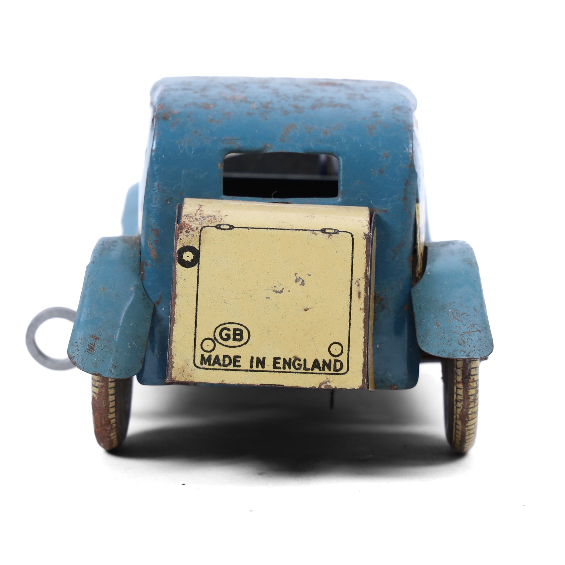 Wells tinplate clockwork limousine, the cream body, with blue roof and lithographed details, with driver and key, H8cm, L23cm