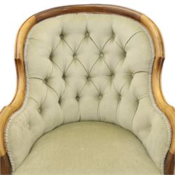 Victorian carved walnut framed armchair with matching stool, the tub-shaped chair with moulded and shaped frame and arm terminals, raised on scrolled cartouche carved supports with scroll feet and castors, buttoned back and sprung seat upholstered in sage green fabric; the small circular footstool with buttoned seat and scroll supports (W36cm H15cm)