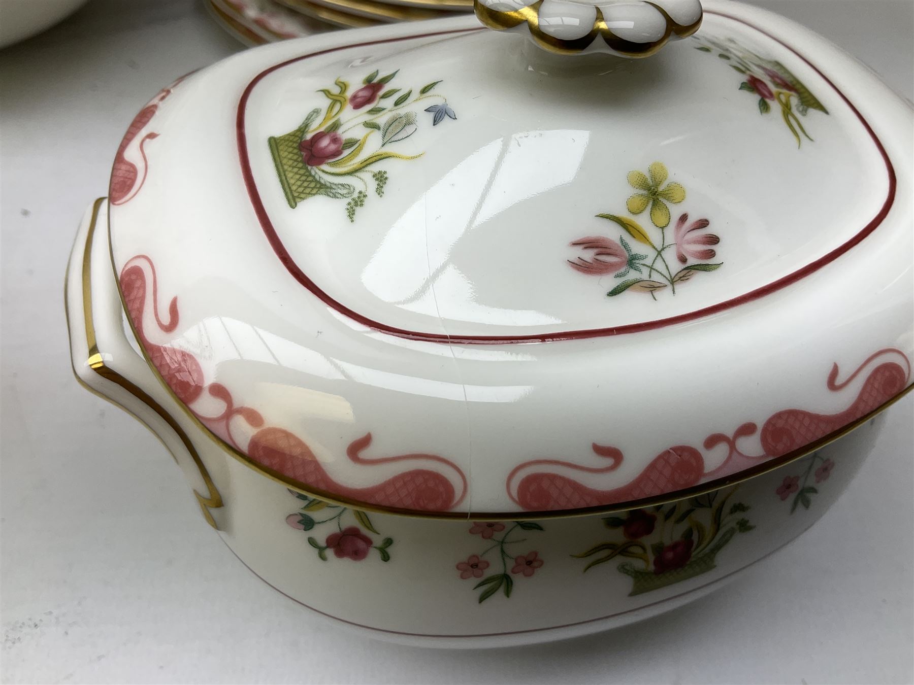 Wedgwood dinner service decorated in the 'Bianca' pattern, to include eight dinner plates, eight bowls, eight side plates, eight twin handled souo bowls, eight soup bowl saucers, eight teacups, eight teacup saucers, six dessert plates and two larger, two twin handled lidded tureens, milk jug, two sauce boats, salt and pepper shakers, oval serving  plate, twin handled sandwich plate, covered sucrier, small rectangular dish and two small circular dishes, all with printed stamp mark beneath