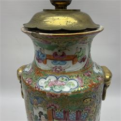 19th century Chinese Canton famille rose vase, converted to a table lamp, of shouldered cylindrical form, with twin gilt lion mask ring handles, the body decorated with four alternating panels of figural scenes and birds and insects, H31cm excluding fitting