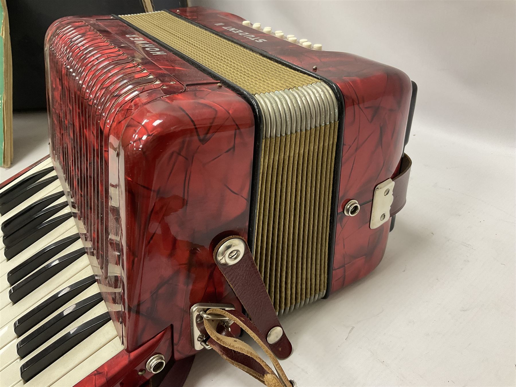 German Hohner student II compact accordion with 26 keys and 12 bass registers in a hard case With tutor