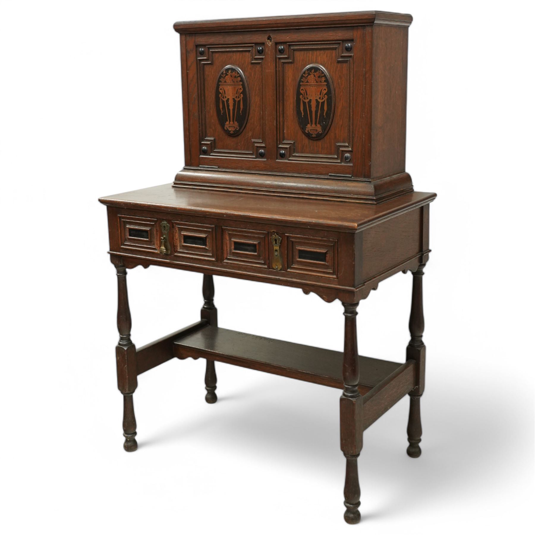 Late 19th to early 20th century Bonheur de Jour or writing bureau, the upper section enclosed by fall front decorated with geometric mouldings and oval inlaid panels depicting floral urns and swags, fitted with document divisions and two small drawers, the lower section fitted with two drawers with applied mouldings, on turned supports united by undertier, 'Hobbs & Co of London' locks