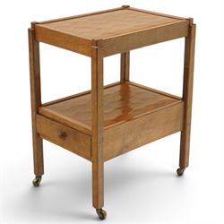 Acornman - oak two tier tea trolley, rectangular adzed top and lower section, with drawer raised on square supports terminating in castors, with carved acorn signature, by the workshop of Alan Grainger of Brandsby
