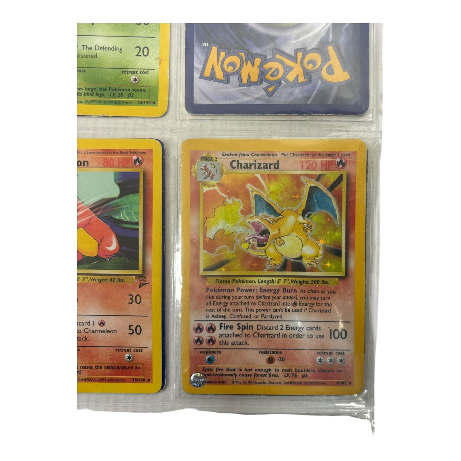 Collection of mainly vintage Pokemon cards including Charizard Base Set Holographic number 4/102 and two Ancient Mew 2000 promo cards, some housed within plastic wallets and some loose