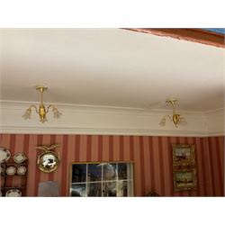 Good quality late 20th century dolls house by M. James dated 1995 in the form of a Beverley East Yorkshire Antique Shop called 'North Bar Antiques'; single-storey single-roomed shop with textured brick walls and flat roof, fully glazed hinged front with recessed hinged customer door and central window to the rear; comprehensively furnished with chests of drawers, pedestal desk, breakfast table, lowboy, two longcase clocks, delft rack with ceramics, occasional tables, pictures, Regency style mirror and collectibles; decorated walls with coving and picture rail and simulated floorboarding; wired for electric lighting; maker's plaque W61cm H42.5cm D41.5cm