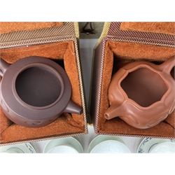 Two Chinese Yixing teapots, Chinese tea bowl hand painted with figures reading, another tea bowl with with underglaze floral panel and another tea bowl with saucer and lid, together with other teacups etc all boxed and with character marks