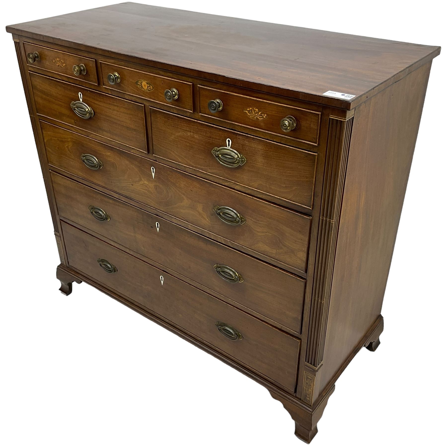 Early 19th century mahogany chest, three shallow frieze drawers over two short and three long cock-beaded drawers, canted corners with reeded moulded square columns, on ogee bracket feet