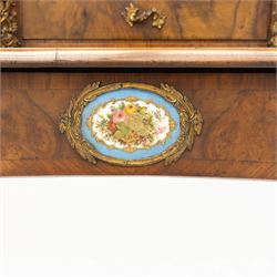 Late 19th-century Louis XV revival gilt bronze mounted and walnut Bonheur-de-Jour, rectangular-shaped serpentine form, with gilt bronze beading, frieze with two blind drawers and gilt bronze handles, centre drawer with large central serves style porcelain plaque, the elevated section with brass gallery above panelled cupboard doors also with serves style porcelain plaques and gilt bronze mounts, interior with single shelf, central section with four drawers each with gilt bronze handles, raised on slender cabriole legs fitted with gilt bronze rococo style masks and sabots