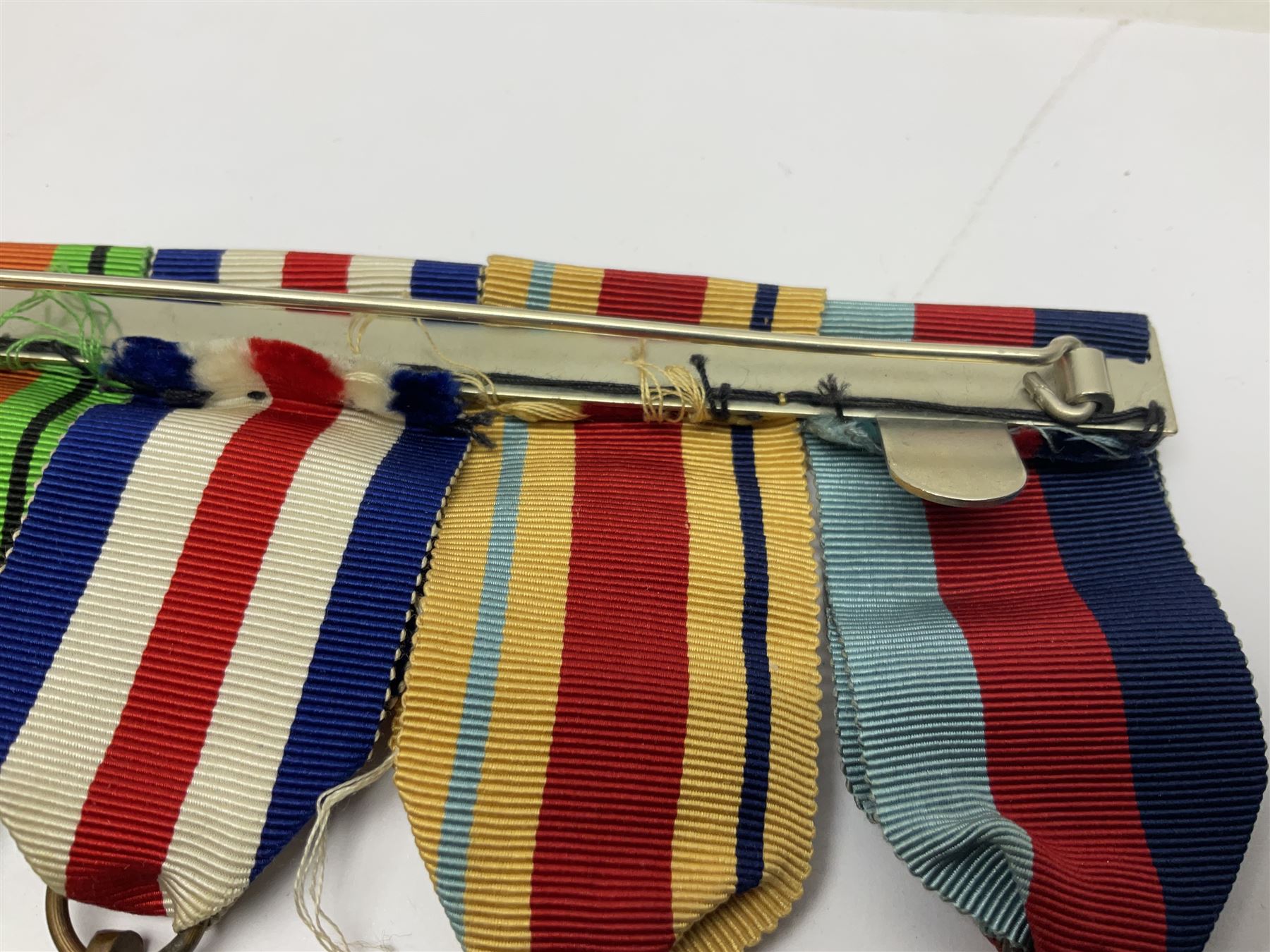 WWII group of five medals comprising 1939-45 War Medal, Defence Medal, 1939-45 Star, Africa Star and France and Germany Star on wearing bar; WWI British War Medal awarded to 142019 Pte. A. Thompson A.S.C.; and boxed King's Badge 'For Loyal Service'