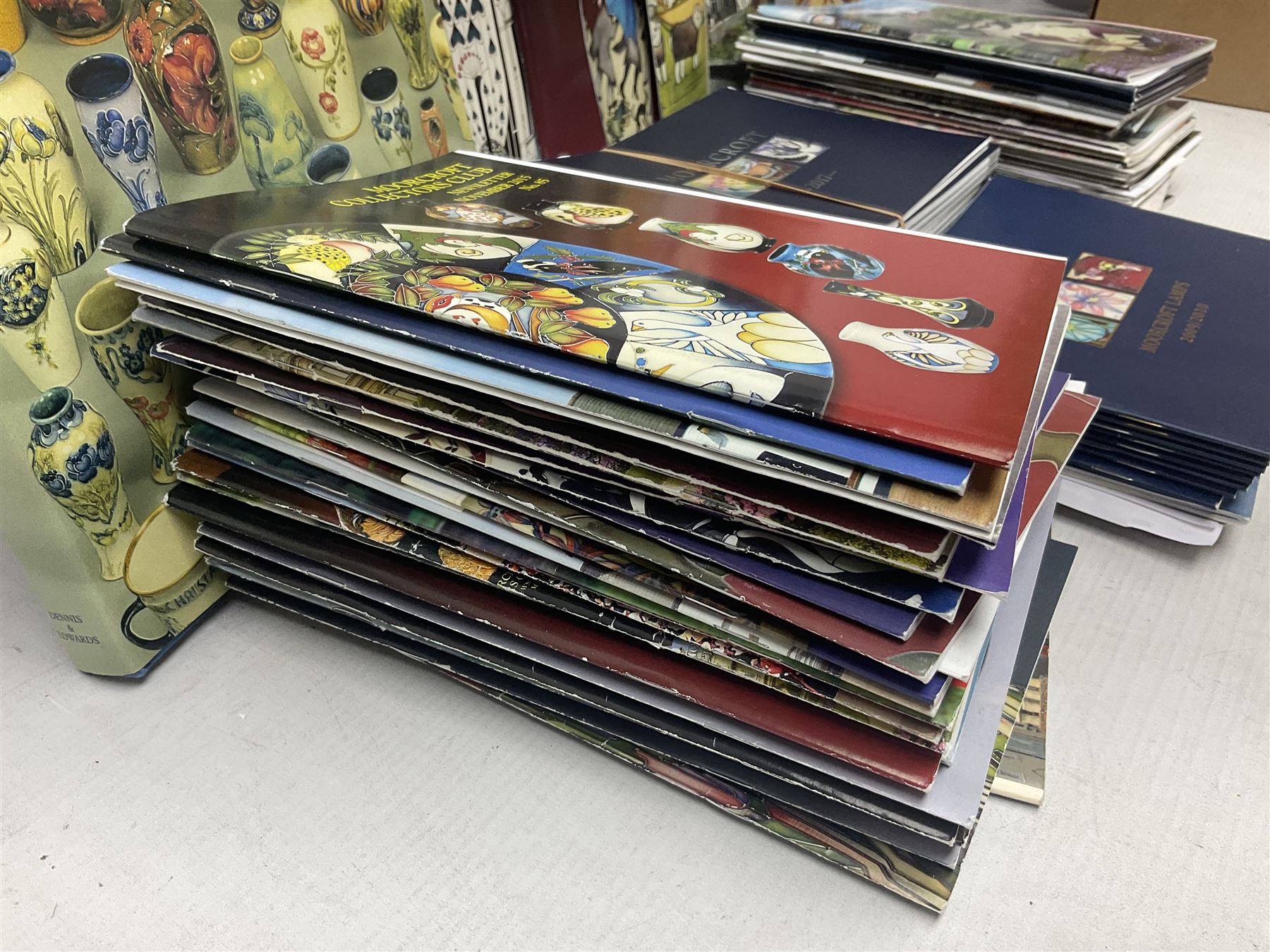 Moorcroft, 1897-1993 revised edition; an illustrated guide to Moorcroft Pottery, a hard back book by Paul Atterbury, together with a quantity of Moorcroft Collector's Club magazines