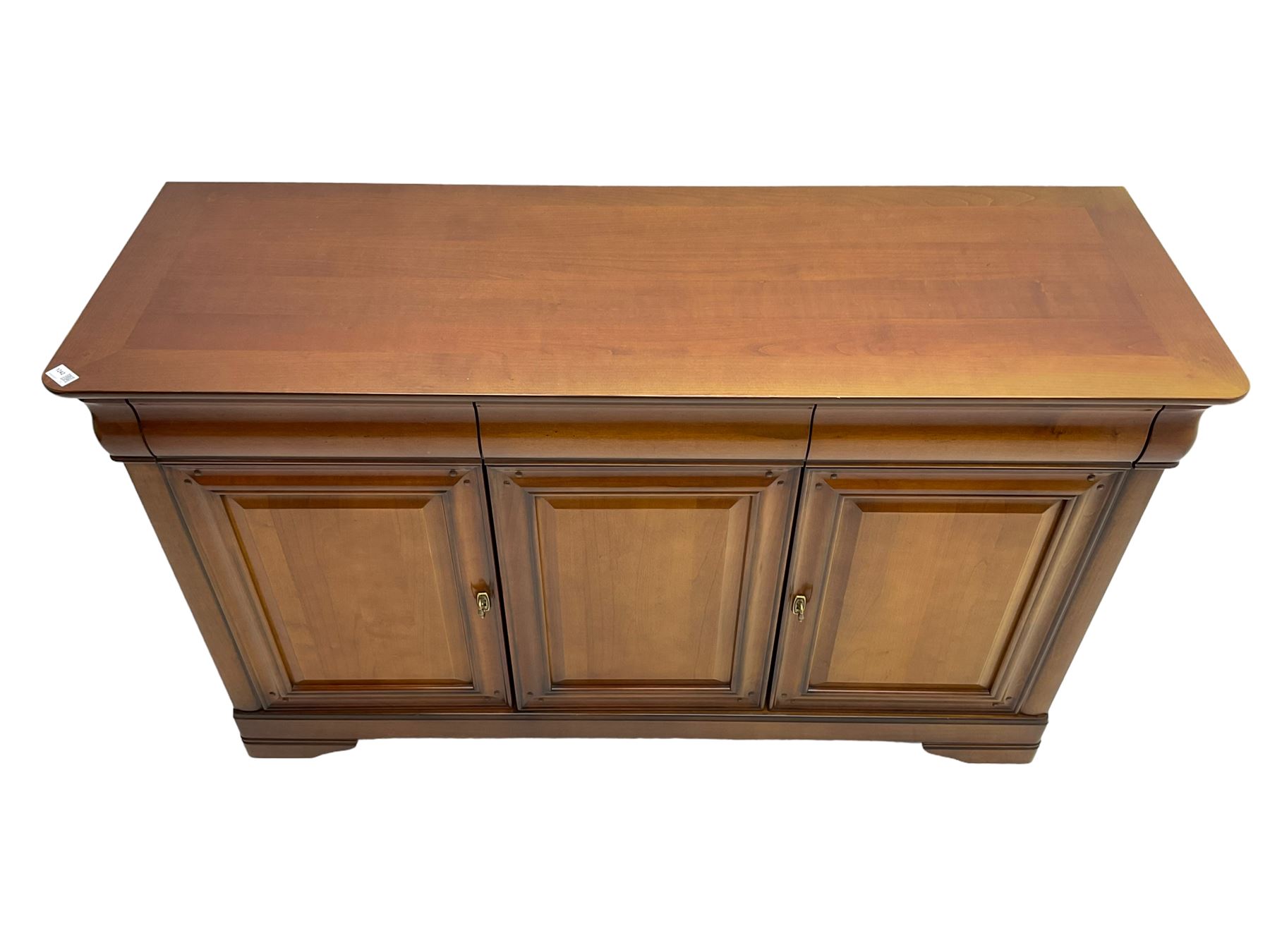 Cherry wood sideboard, fitted with three cushion drawers over three panelled cupboard doors, on bracket feet