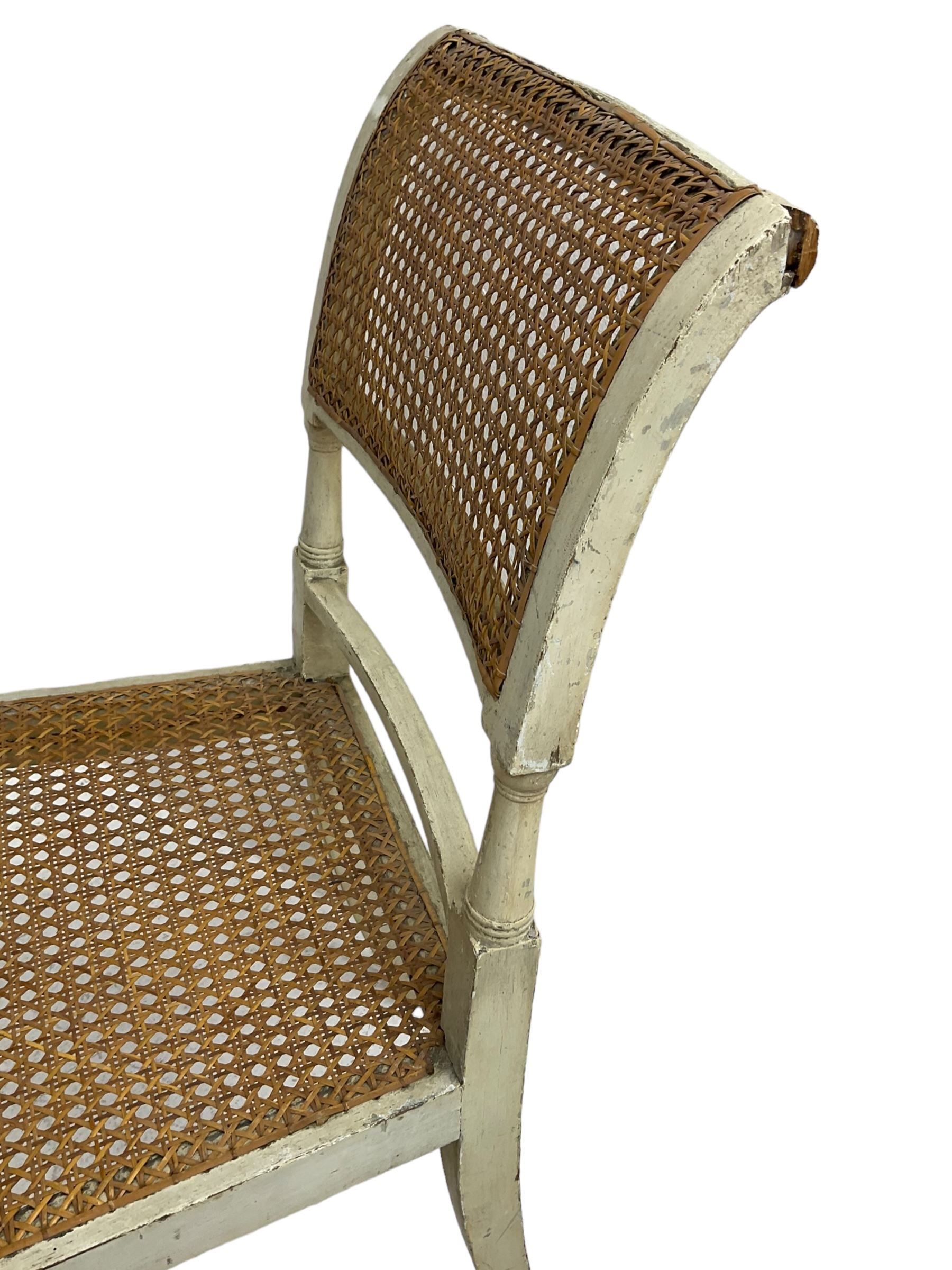 Collection of Regency dining chairs - set of four Regency painted beech dining chairs, with cane seat and back, on collar turned supports with splayed feet (W46cm, H84cm); a pair of Regency ebonised dining chairs (W47cm, H77cm); and a single Regency dining chair, the cresting rail painted with floral cornucopias and central putto vignette, X-frame back over cane seat, on collar turned front supports painted with foliage (W46cm, H84cm) (7)