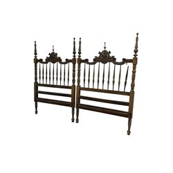 Pair Spanish stained beech single 3' bedsteads, spindle turned backs and carved with scrolling floral decoration 