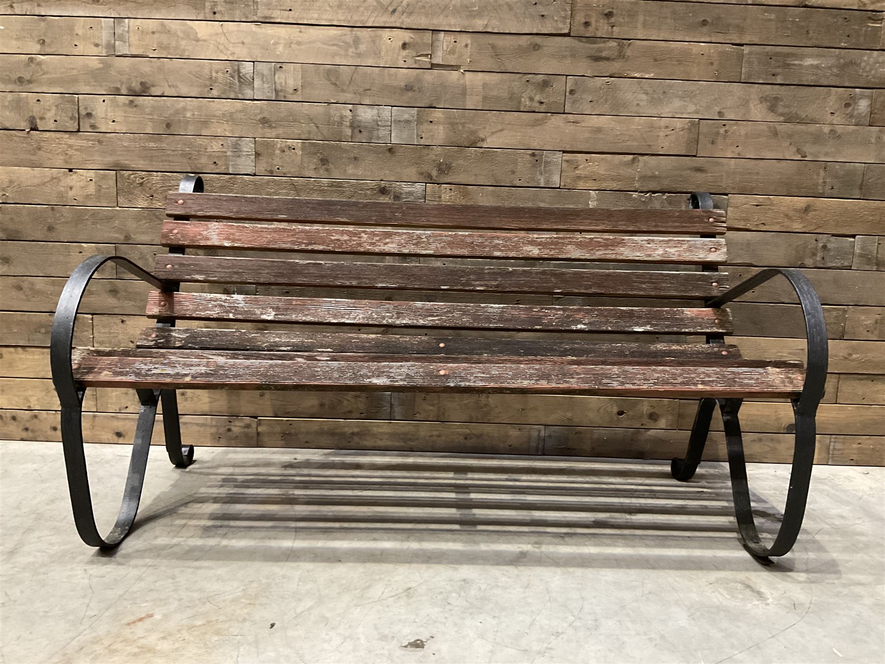Early 20th century black painted wrought iron and wood slatted garden bench