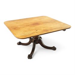 Large Regency mahogany breakfast table, figured rectangular tilt-top with rounded corners, on wide turned pedestal with four out-splayed moulded supports, paw carved terminals with recessed castors 