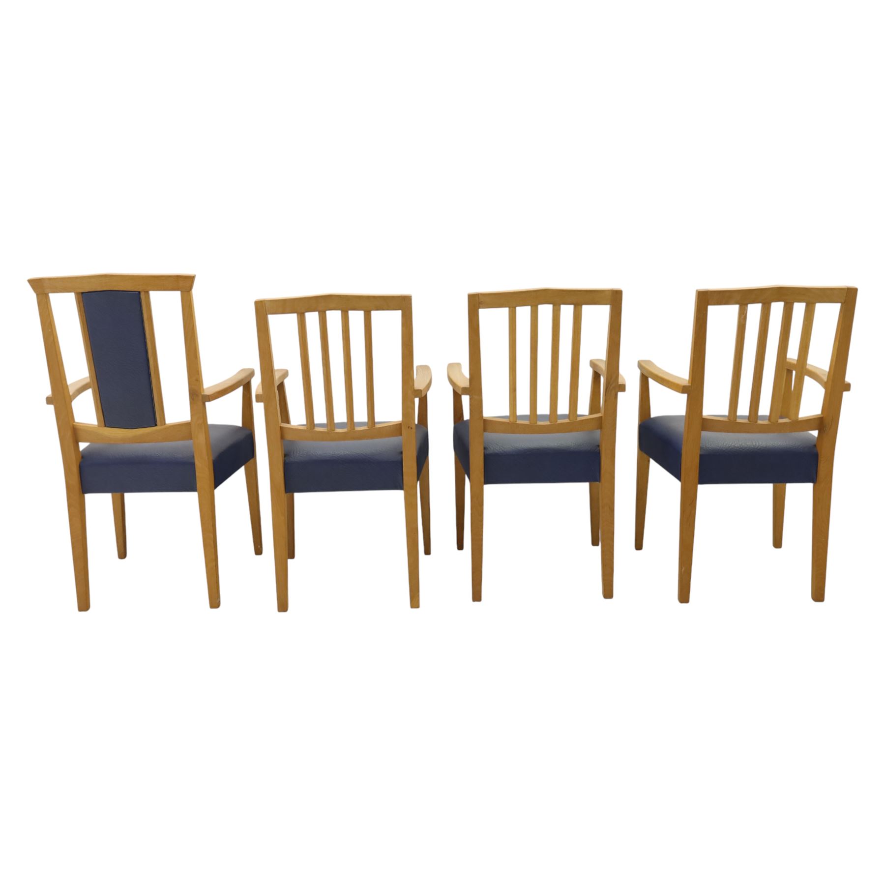 Modern twelve oak dining chairs including one 'Chairmans' chair, solid oak construction, slatted back and arm rests, blue leatherette padded seat, on tapered square supports 