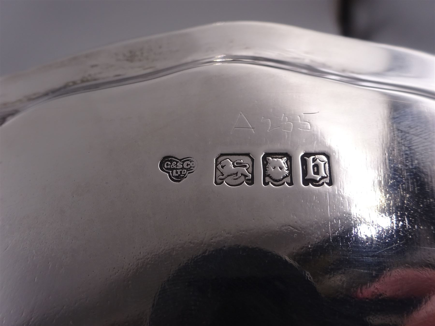 Early 20th century silver waiter, of hexagonal form, with oblique gadrooned rim, upon four ball and claw feet, hallmarked Goldsmiths & Silversmiths Co Ltd, London 1919, D21cm