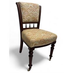 Victorian mahogany centre table, circular top above turned pedestal, terminating on three cabriole legs with scroll feet on porcelain castors, and six scroll carved upholstered dining chairs, with cushion and spindle turned backs, centre table  118x74cm, dining chairs 89x46x50cm