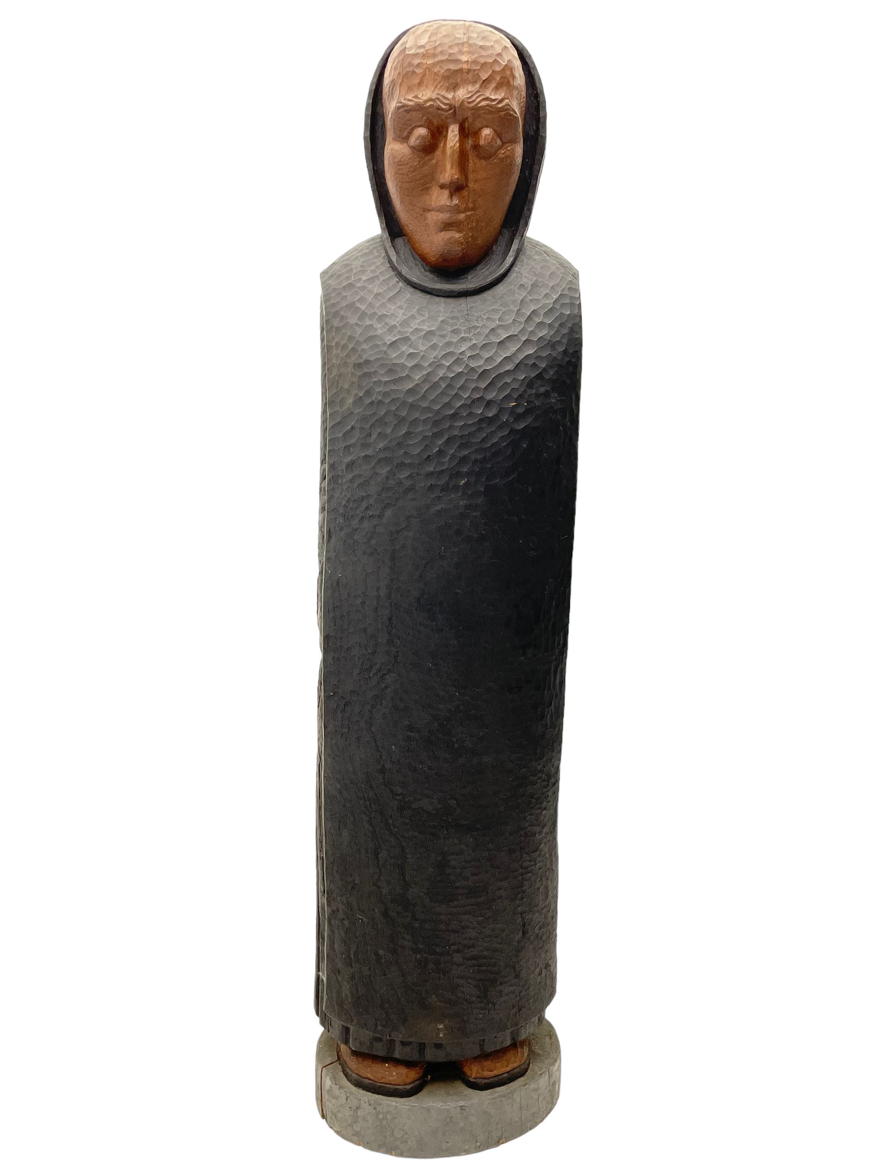 John Bunting FRBS, FRCA (1927-2002): Carved sculpture of a standing Monk in ebonised robes