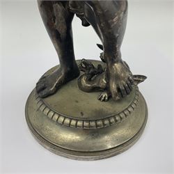 20th century silver plated figure, modelled as a classical male figure, possibly Prometheus, holding flames, one foot resting atop a small dragon, upon a circular spreading base, overall H37.5cm