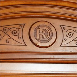 Victorian neoclassical style satinwood triple-section wardrobe, the central mirror section and arched pediment with carved monogram flanked by two panelled crossbanded doors, revealing two drawers and grooves for shelves, the hanging cupboards each with a single drawer, the whole supported on a plinth base