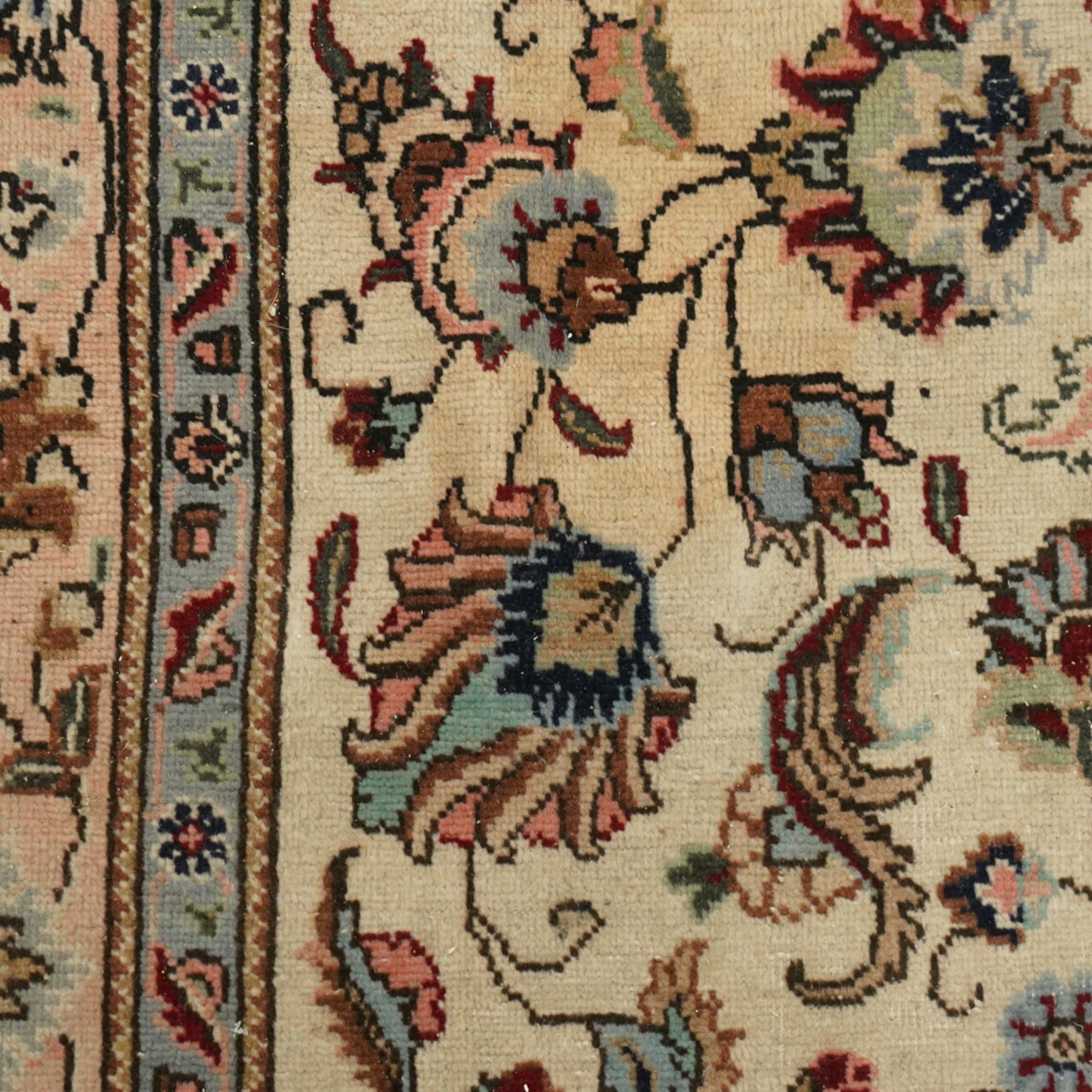 Persian Kashan rug, ivory ground field decorated with an all-over design of scrolling vines and stylized palmettes in pastel tones and conforming floral borders