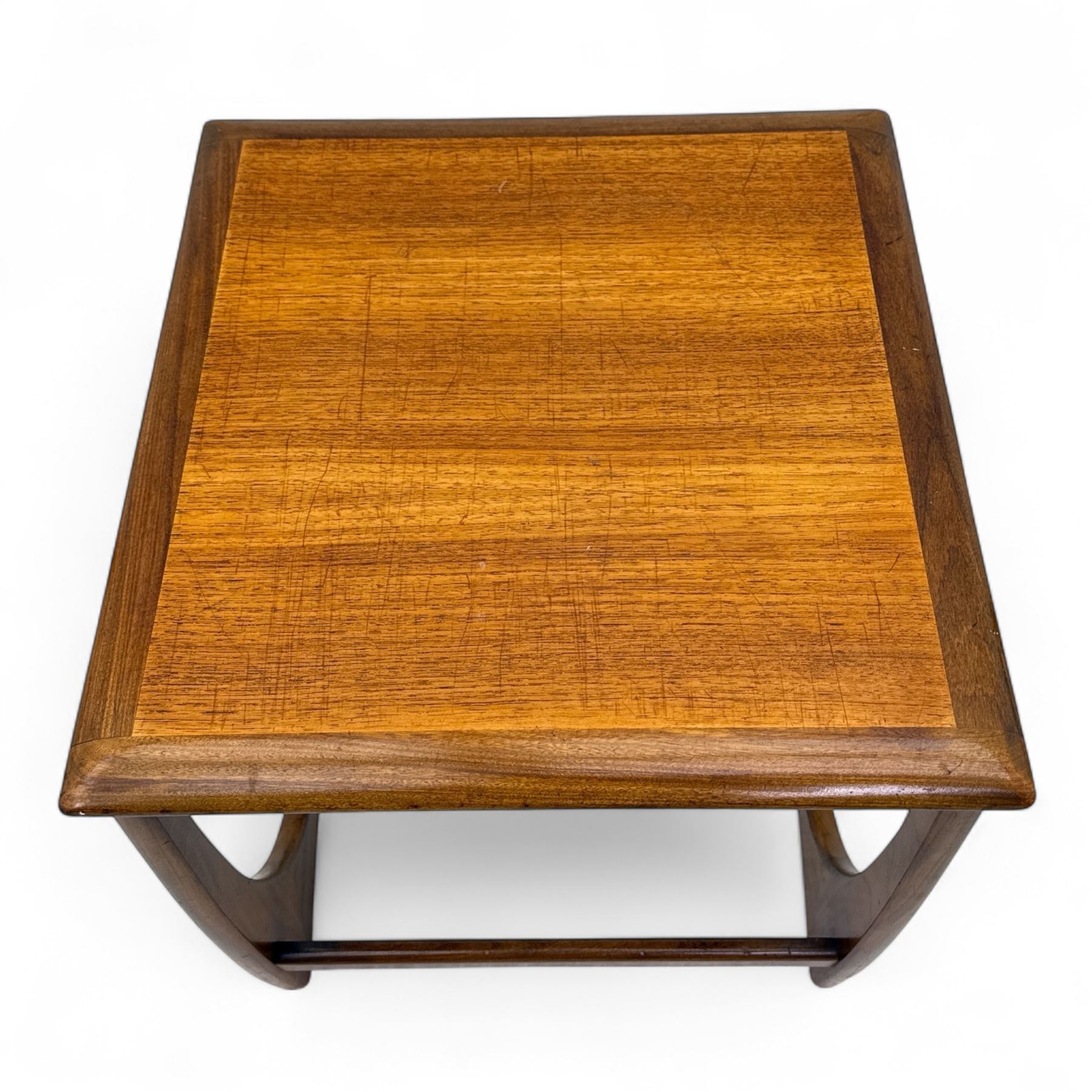 G-Plan - 'Astro' mid mid-century long teak coffee table with two nesting tables, rectangular top with outer banding, above two square top occasional tables on U-shaped end supports united by a stretcher