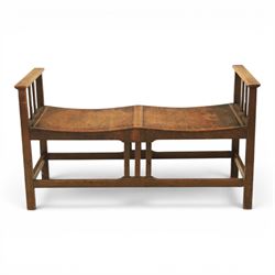 Arts and Crafts oak window bench, with flat armrests flanking two dished seats, raised on ...