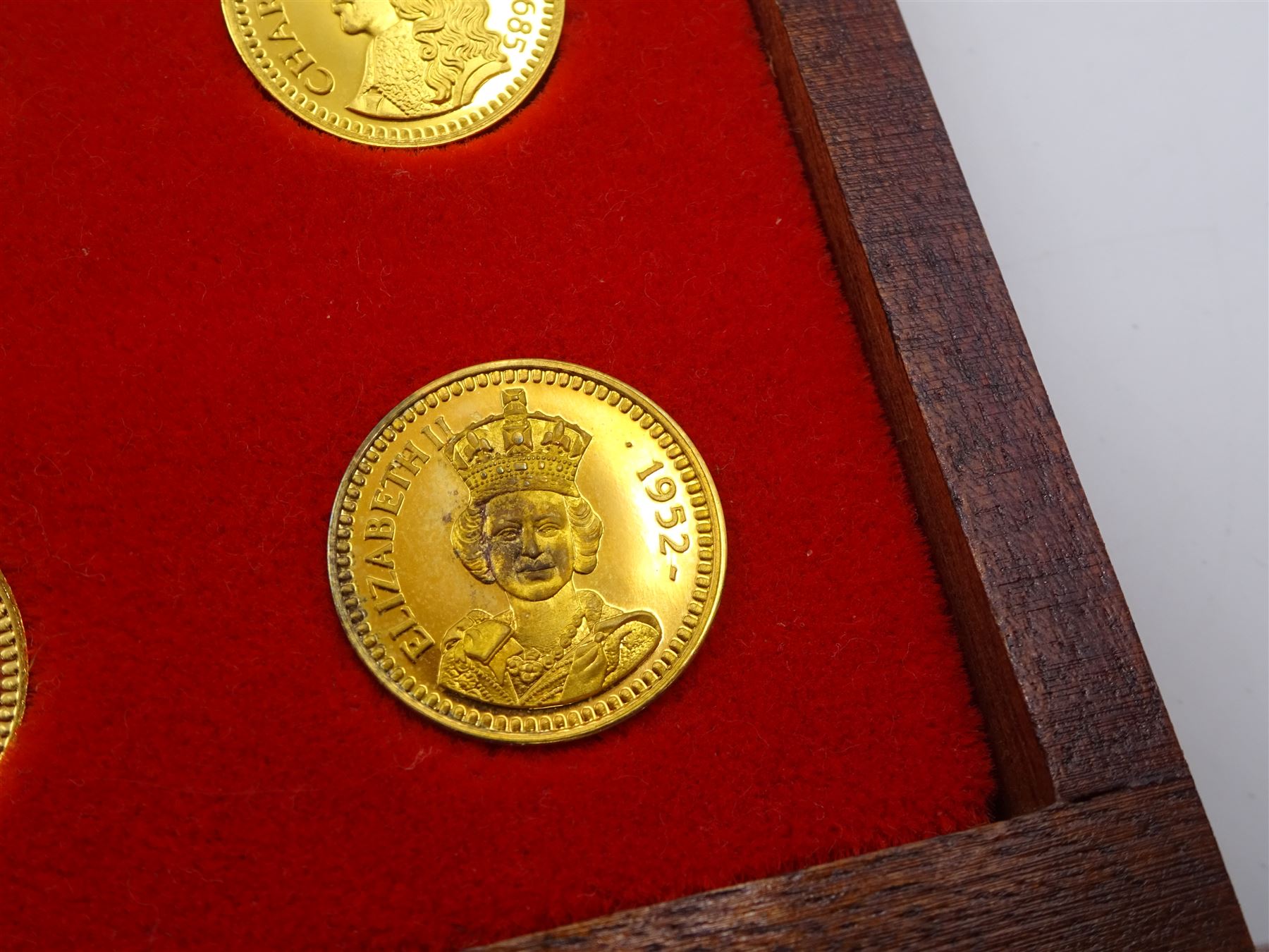 Danbury Mint, Our Royal Sovereigns Collection, seventy 22 carat gold plated silver medallions depicting the complete line of British monarchs to mark the 1200th anniversary of the first coronation, contained within wooden table top collectors cabinet with two drawers, with certificate of authenticity, with two drawers, hallmarked Danbury Mint, London various dates