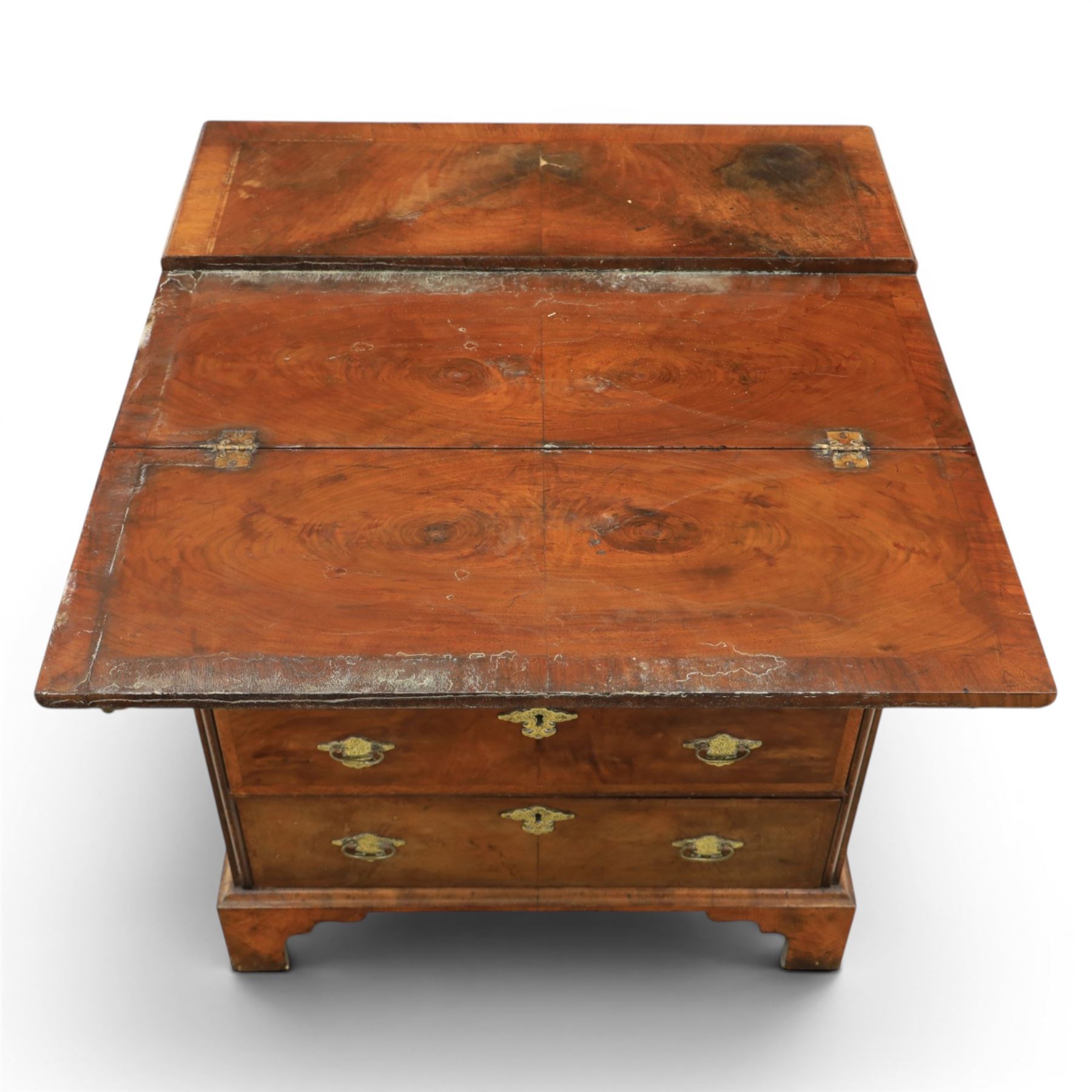 Early 20th century Georgian design figured walnut bachelor's chest, with half fold over top and lopers, over three drawers with pierced brass handles and escutcheons 