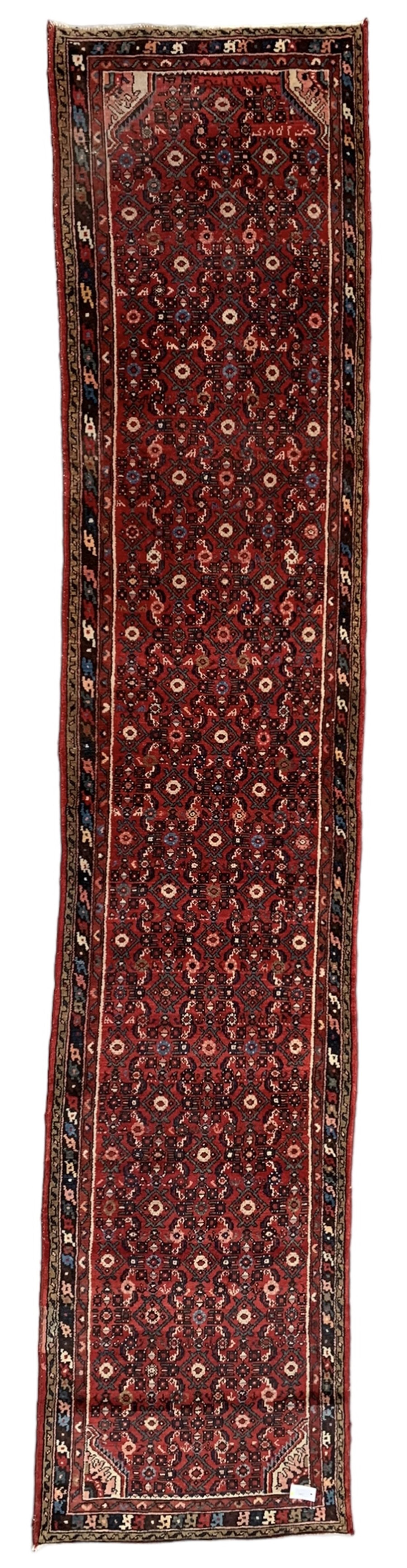 Persian crimson ground runner, the field decorated with Herati motifs,  three-band border, the main band decorated with repeating flowerheads 