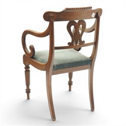 Set of eight (6+2) Regency period mahogany dining chairs, the ornately carved cresting rail of gadrooned and foliate design, over a pierced swan-neck splat with scrolling foliate carving, the carvers with scrolled arm terminals, over teal-upholstered drop-in seats, raised on Gillows-design reeded and tapering front supports, retailed by David Hick Interiors, Jersey