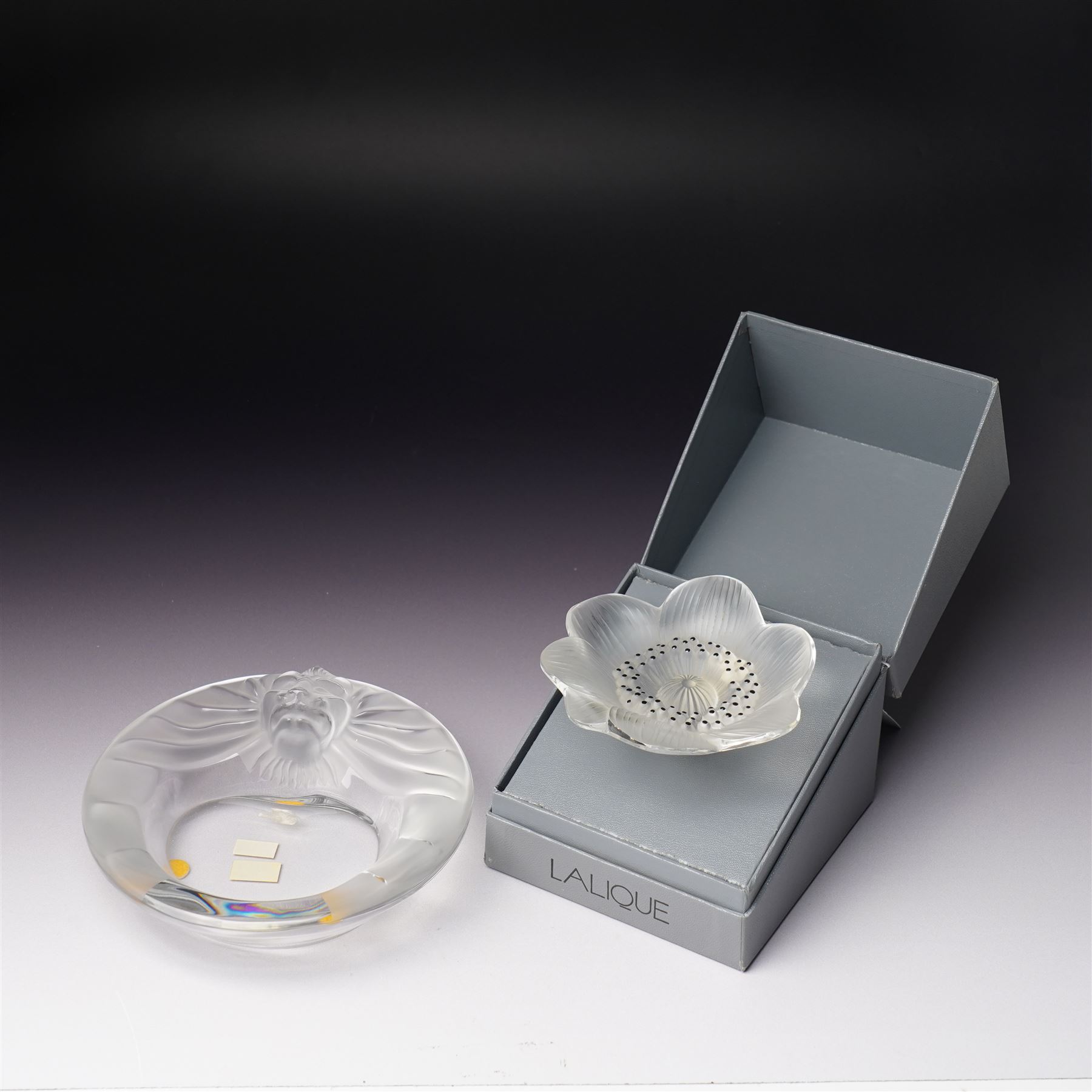 Lalique Lions Head glass ashtray and an 'Anemone' flower, both marked Lalique, France and boxed (2)