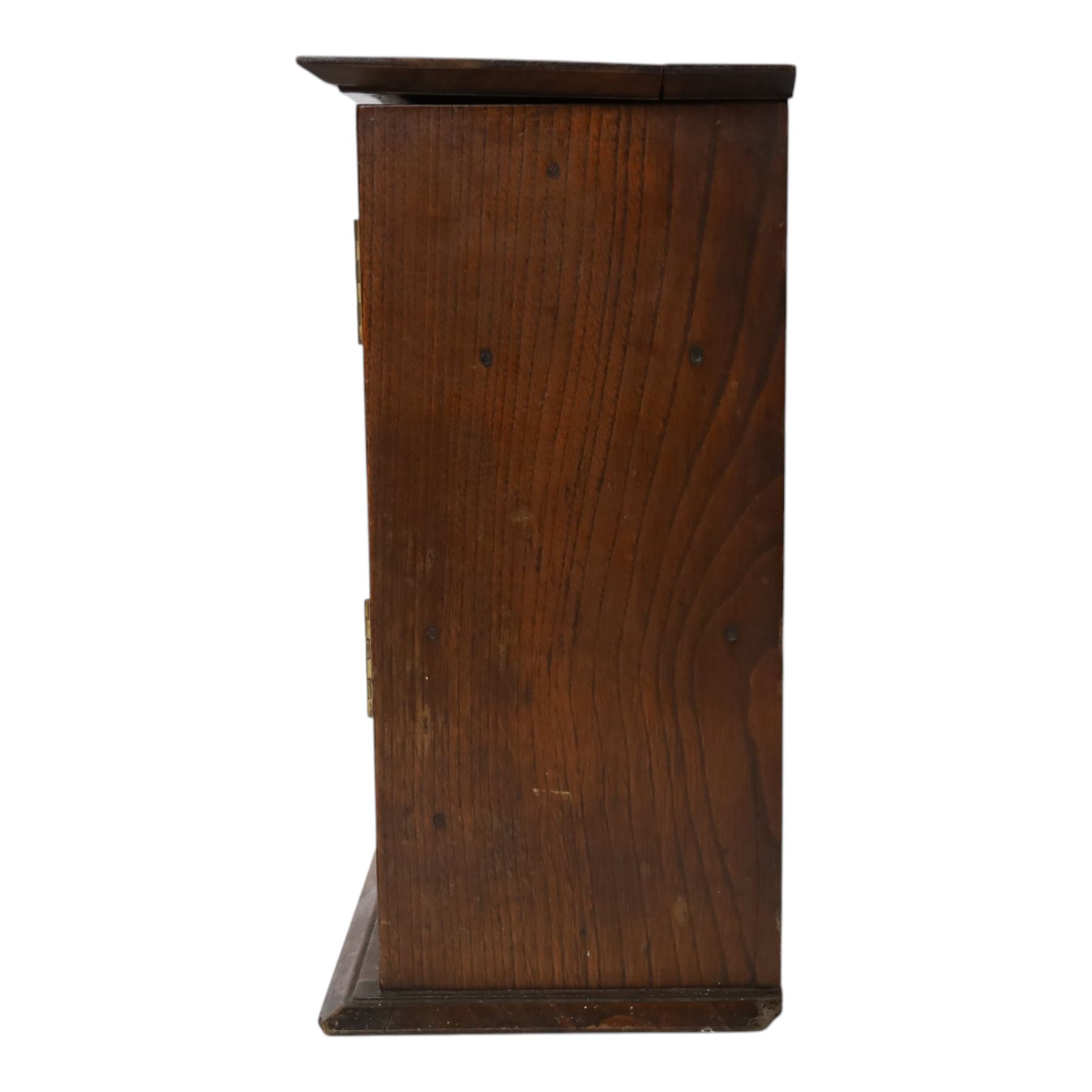 Oak smoking cabinet, with hinged lid, the glazed door opening to reveal a fitted interior, over a single drawer, together with a wooden tobacco box with lid, cabinet H39cm