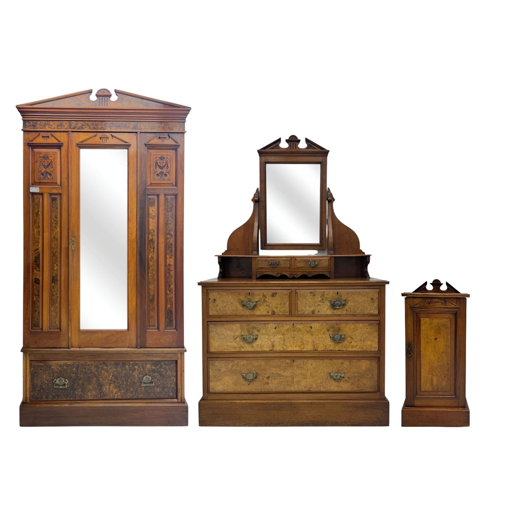 Victorian walnut bedroom suite - wardrobe, dressing chest and bedside cupboard, comprising a full-length wardrobe with broken pediment and central mirrored door, large lower drawer, a matching dressing table with bevelled swing mirror over two trinket drawers and two short drawers over two long drawers, and a single-door bedside cupboard, all with moulded edges, decorative panel work and shaped aprons