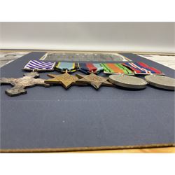 Warrant Officer Gordon Pearce D.F.C. R.A.F.V.R. - display of five medals comprising copy Distinguished Flying Cross, copy Air Crew Europe Star, 1939-45 Star, 1939-45 War Medal and Defence Medal; framed with RAF cap badge, two copy photographs in uniform and copy of investiture letter; mounted and glazed in pine frame 34 x 66cm