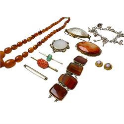Three 9ct gold brooches, including two stone set examples, silver charm bracelet, amber type beads and gilt metal jewellery