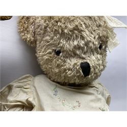 Two early 20th century straw filled jointed teddy bears, first example wearing a tweed jacket bearing Geoffrey Saville label, with leather padded paws and ears, horizontally stitched nose and humpback; second example with applied eyes, vertically stitched nose and faux leather paw pads, both with growler mechanisms, tallest H74cm 