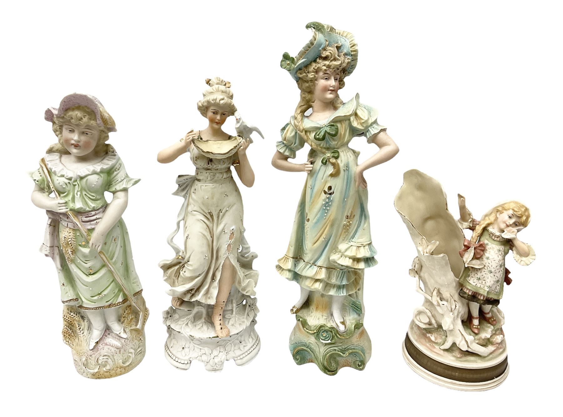 Late 19th century continental spill vase as a young girl standing beside an open tree trunk H21cm; and three German bisque figures (4)